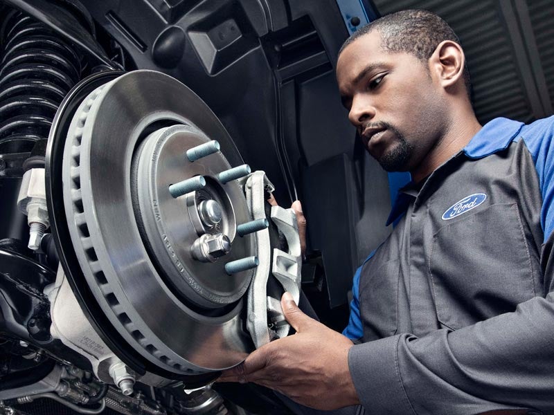 Certified Ford Technician Checking Brake Caliper