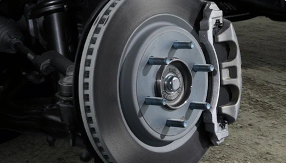 A mechanic inspecting brake rotors and pads